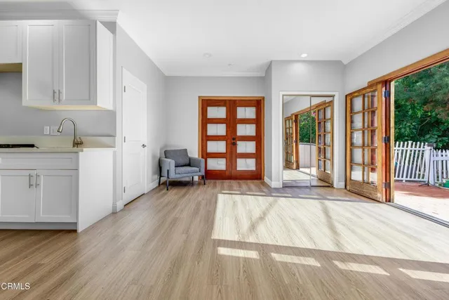 a view of a room with wooden floor and cabinet