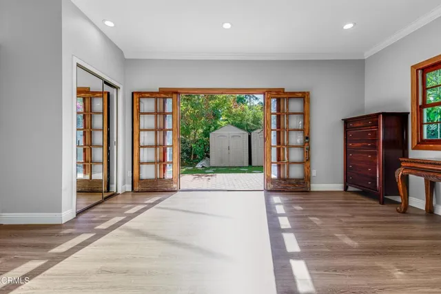 a view of an empty room with a fireplace and a window