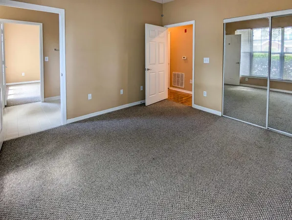 an empty room with glass door and shower