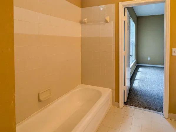 a bathroom with a tub and shower