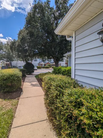 a pathway of a house with a yard