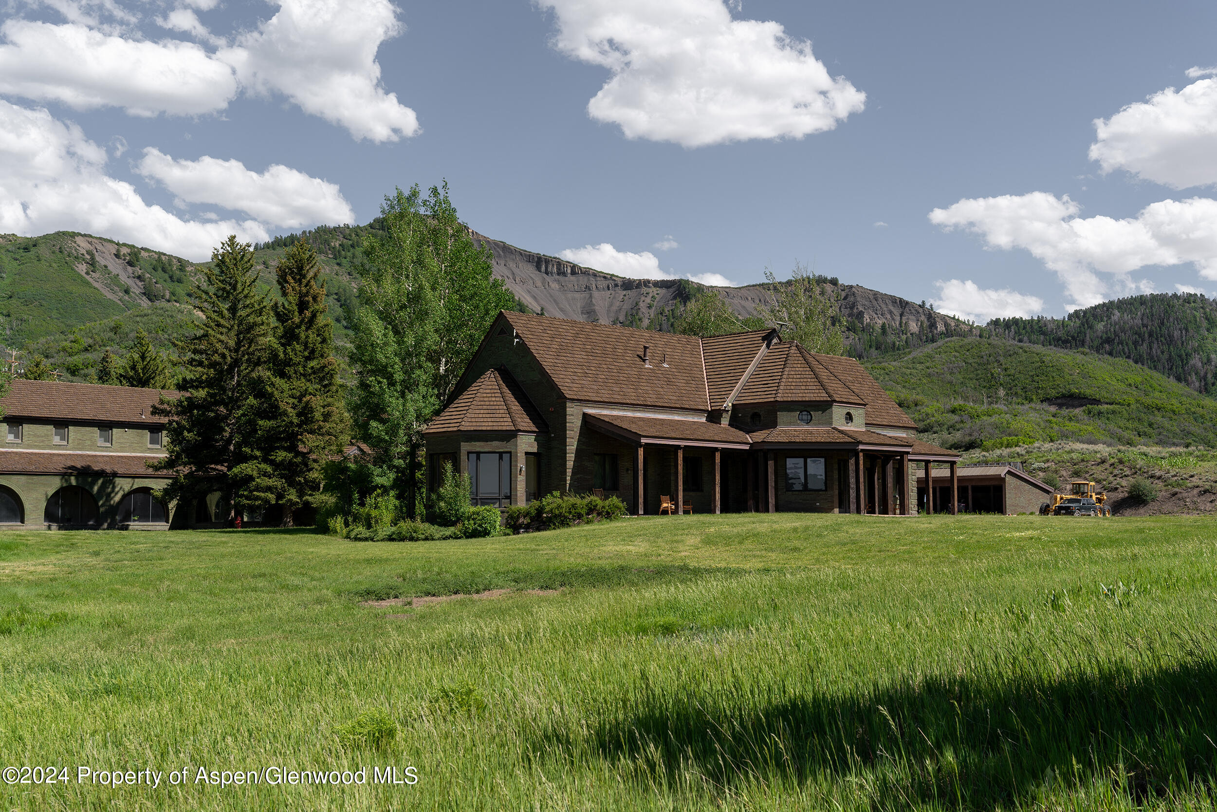 1012 Monastery Road Snowmass, CO 81654 - Photo 19 of 96 a view of a house with a big yard and potted plants