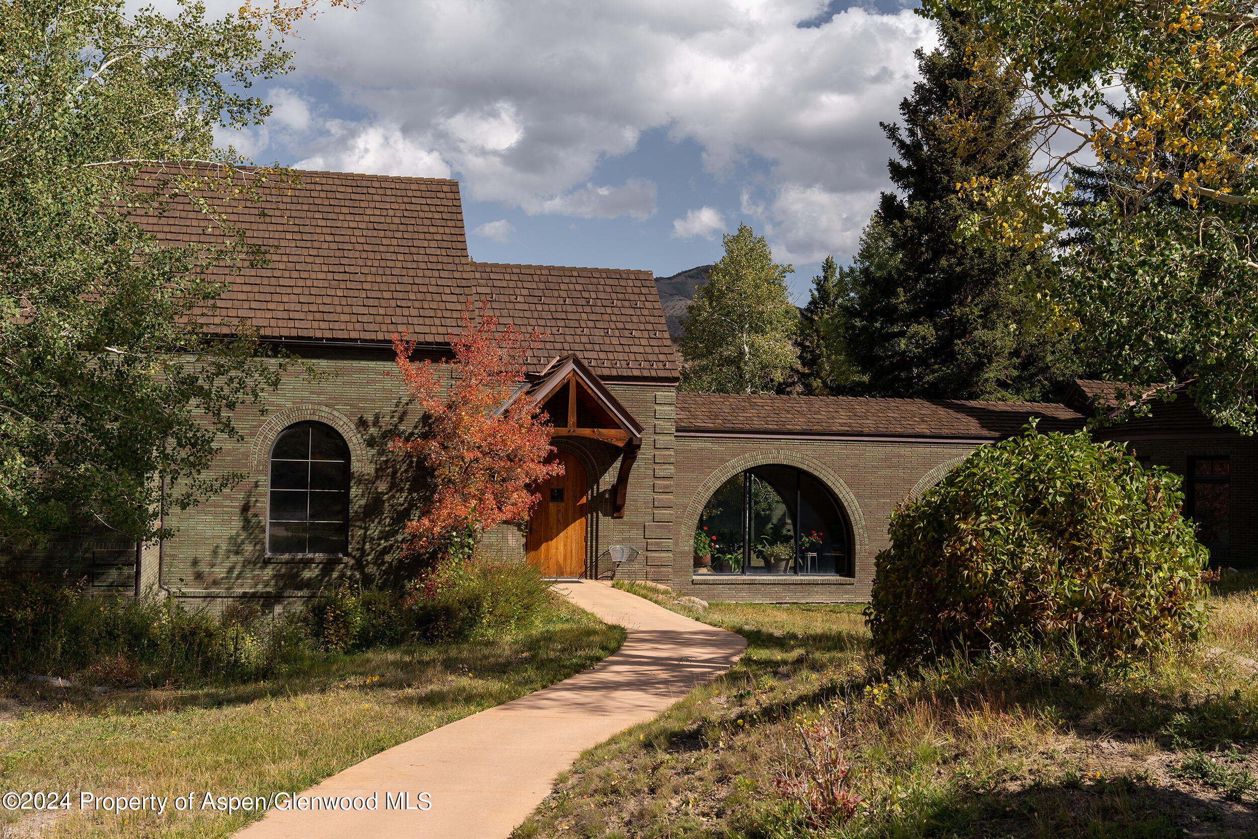 1012 Monastery Road Snowmass, CO 81654 - Photo 20 of 96 a view of a house with large windows and a yard