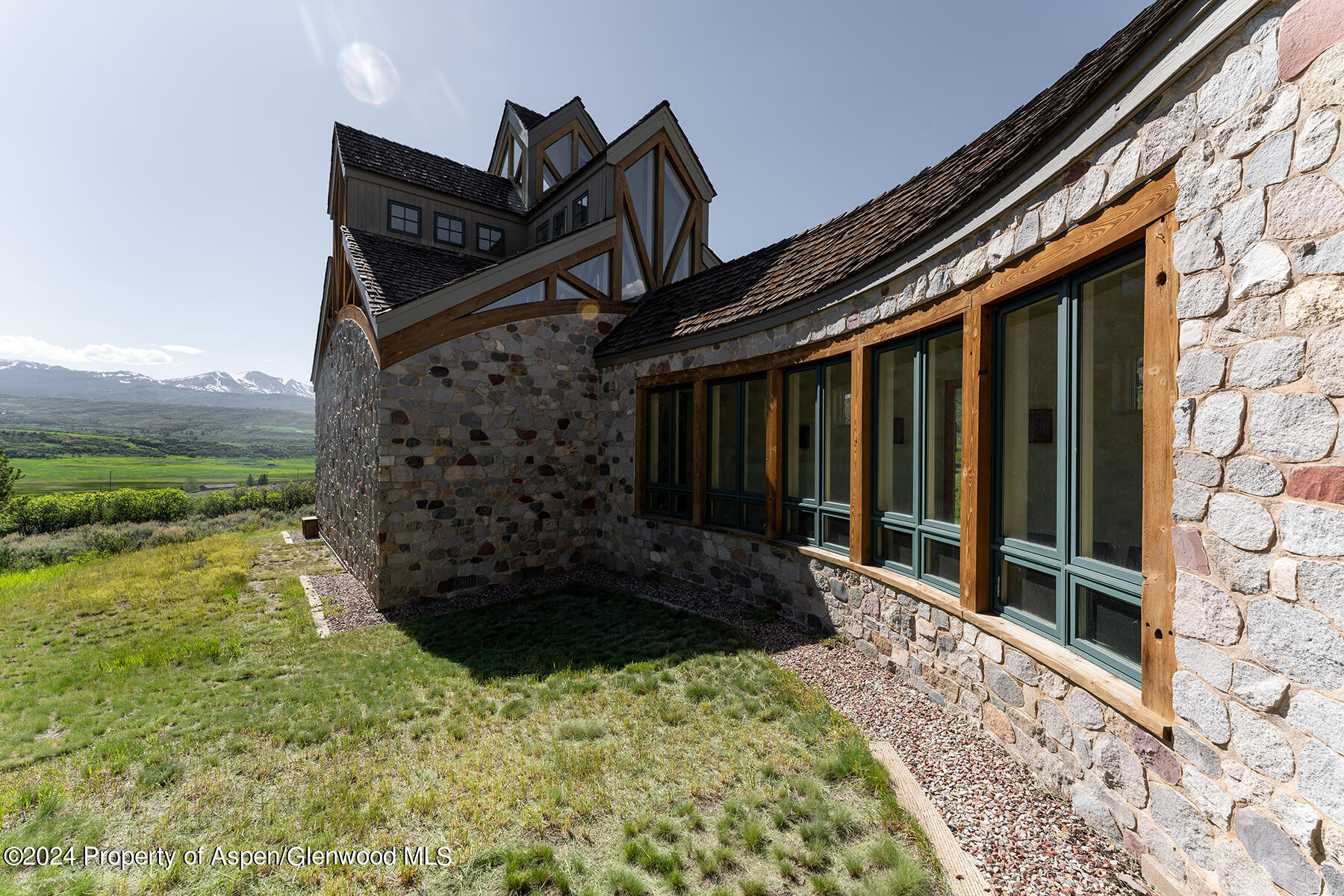 1012 Monastery Road Snowmass, CO 81654 - Photo 32 of 96 a black and white house with yard in front of it