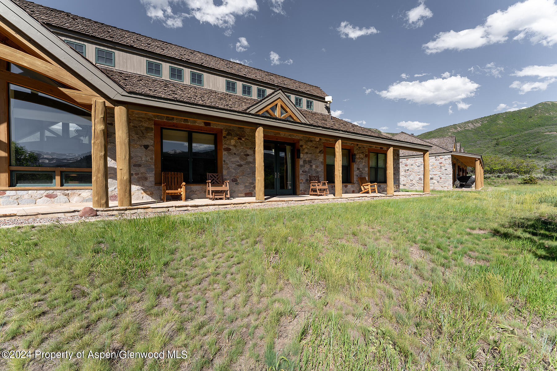 1012 Monastery Road Snowmass, CO 81654 - Photo 34 of 96 a view of a house with a small yard and sitting area