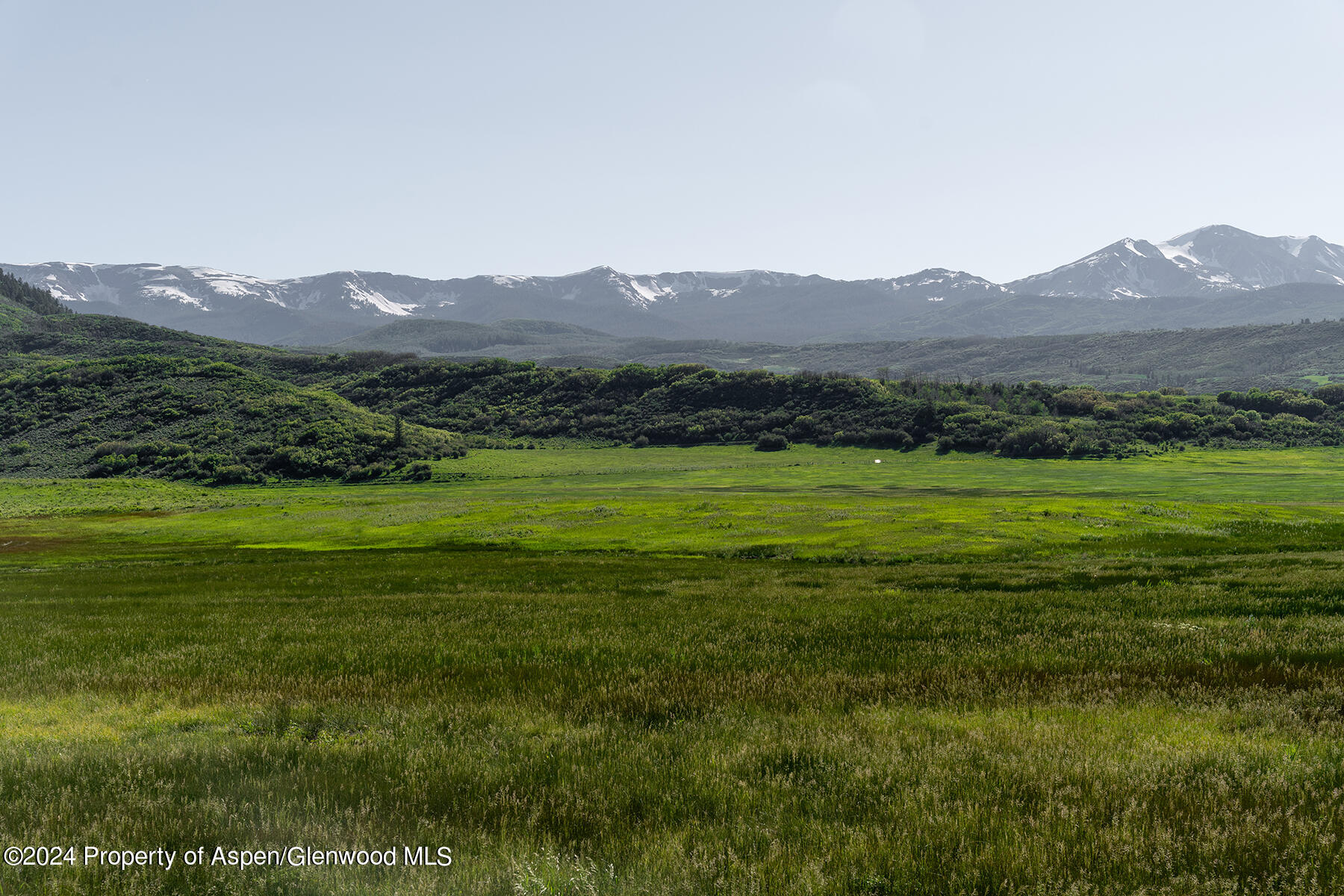 1012 Monastery Road Snowmass, CO 81654 - Photo 90 of 96 a view of a lush green hillside and a houses