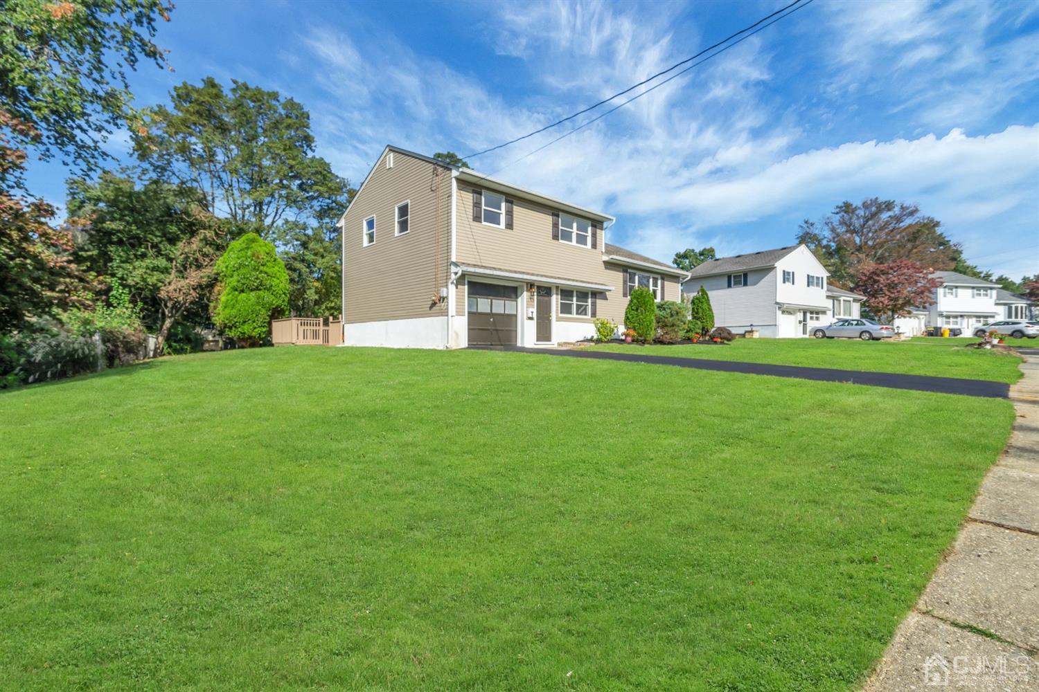 9 Valiant Road East Brunswick, NJ 08816 - Photo 2 of 41 a view of a big house with a big yard and large trees