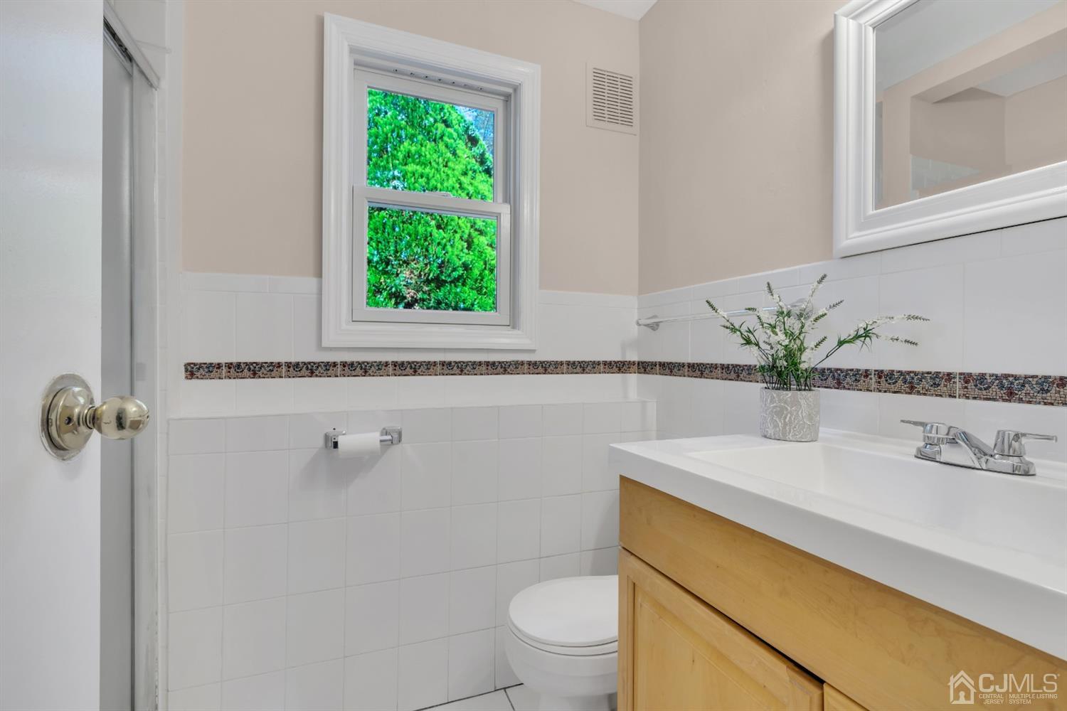 9 Valiant Road East Brunswick, NJ 08816 - Photo 11 of 41 a bathroom with a sink a toilet and a mirror