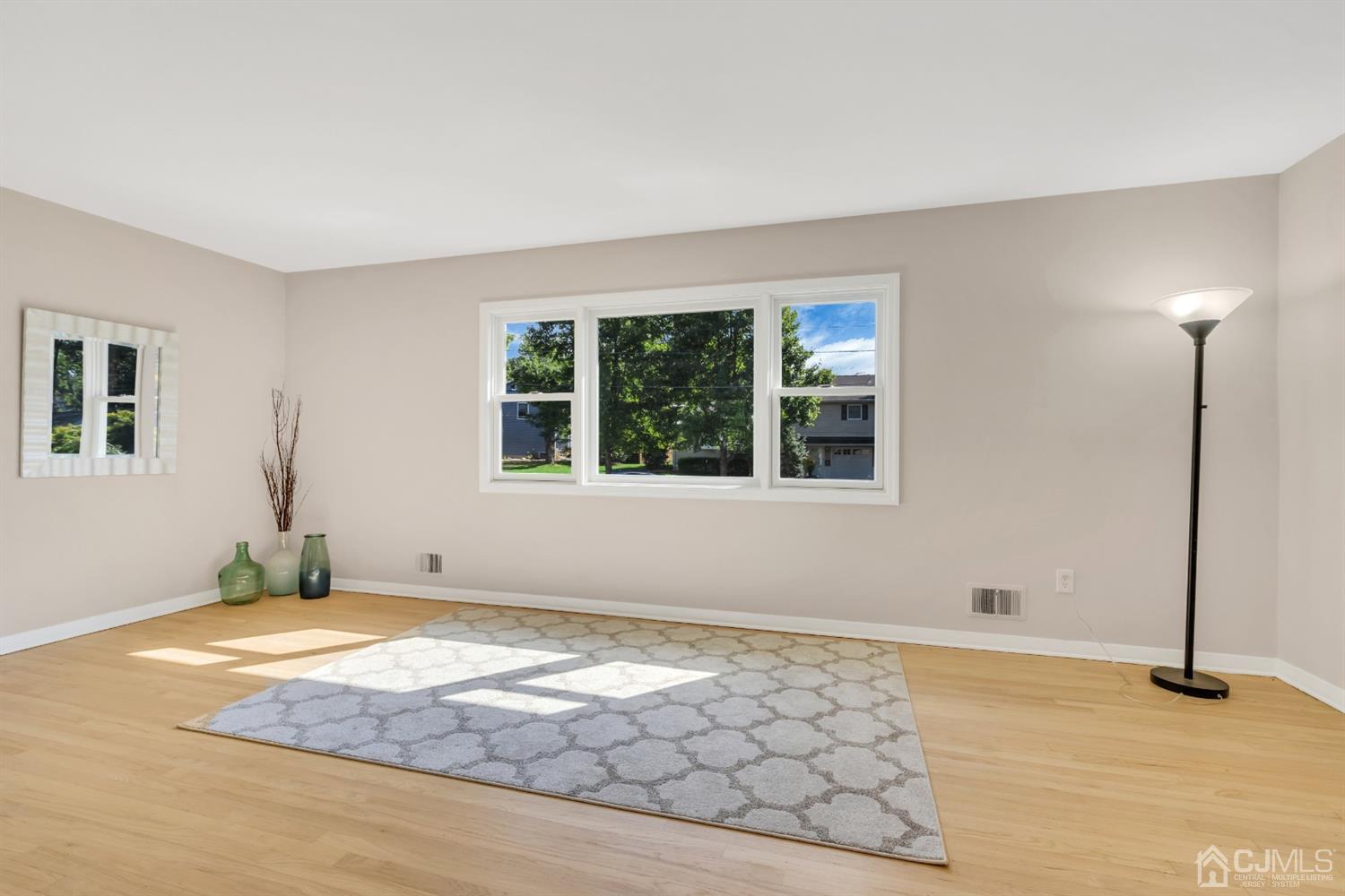 9 Valiant Road East Brunswick, NJ 08816 - Photo 12 of 41 a view of an empty room with window and wooden floor