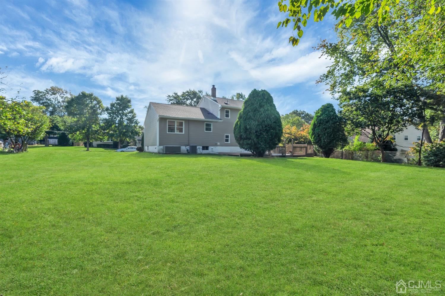 9 Valiant Road East Brunswick, NJ 08816 - Photo 3 of 41 a view of a big house with a big yard and large trees