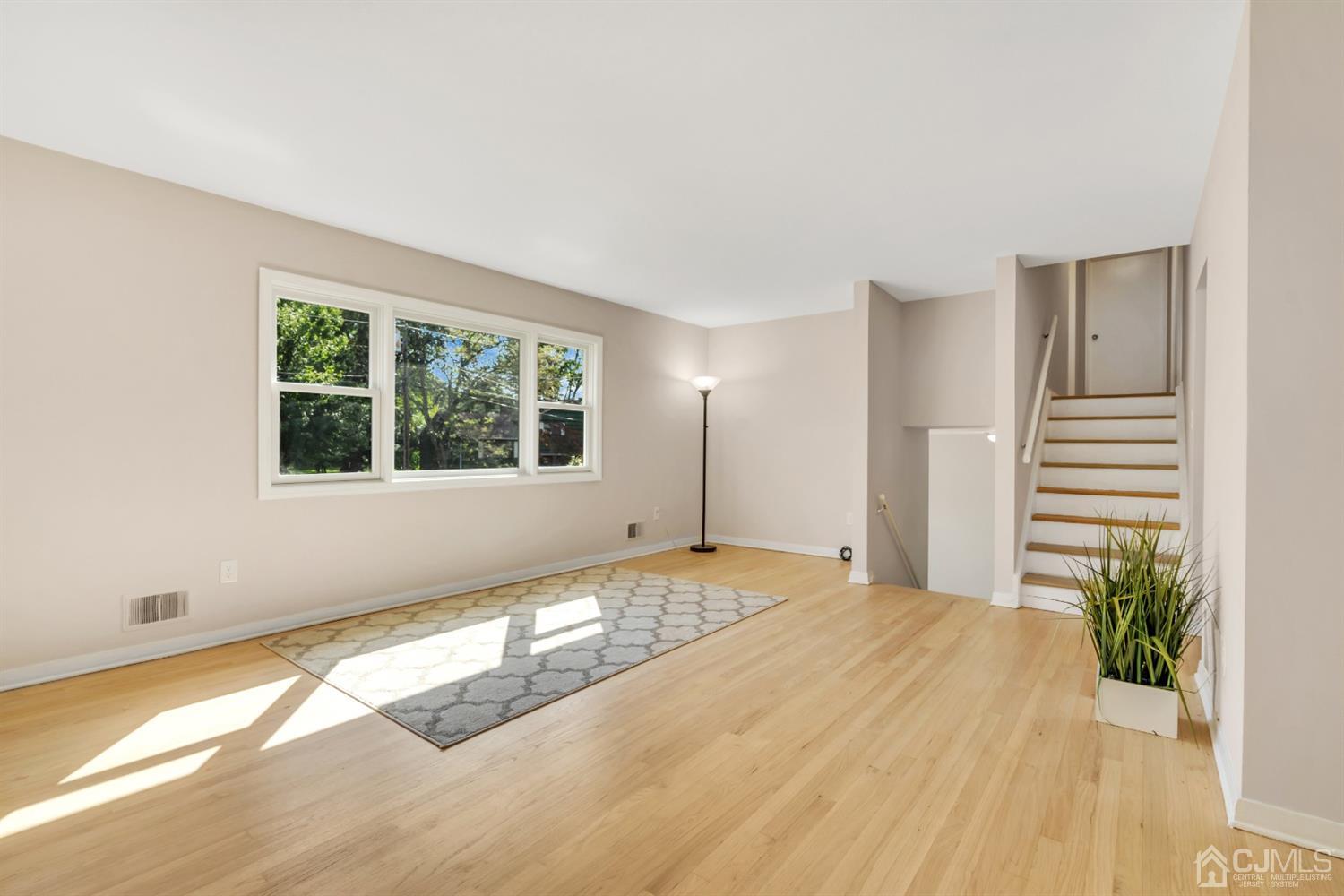 9 Valiant Road East Brunswick, NJ 08816 - Photo 26 of 41 a view of an empty room with wooden floor and a window
