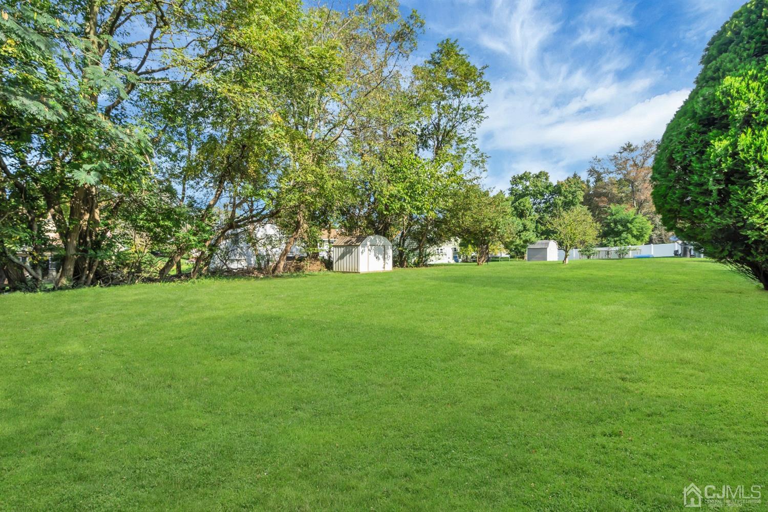 9 Valiant Road East Brunswick, NJ 08816 - Photo 4 of 41 a view of green field with trees in the background