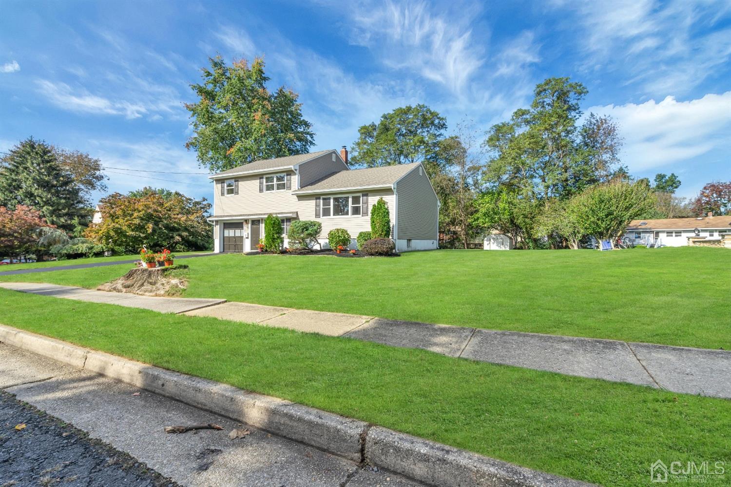 9 Valiant Road East Brunswick, NJ 08816 - Photo 40 of 41 a front view of a house with a yard and trees