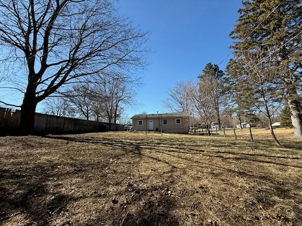 a big yard with road and a building