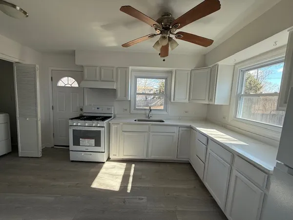 a kitchen with a stove oven and sink