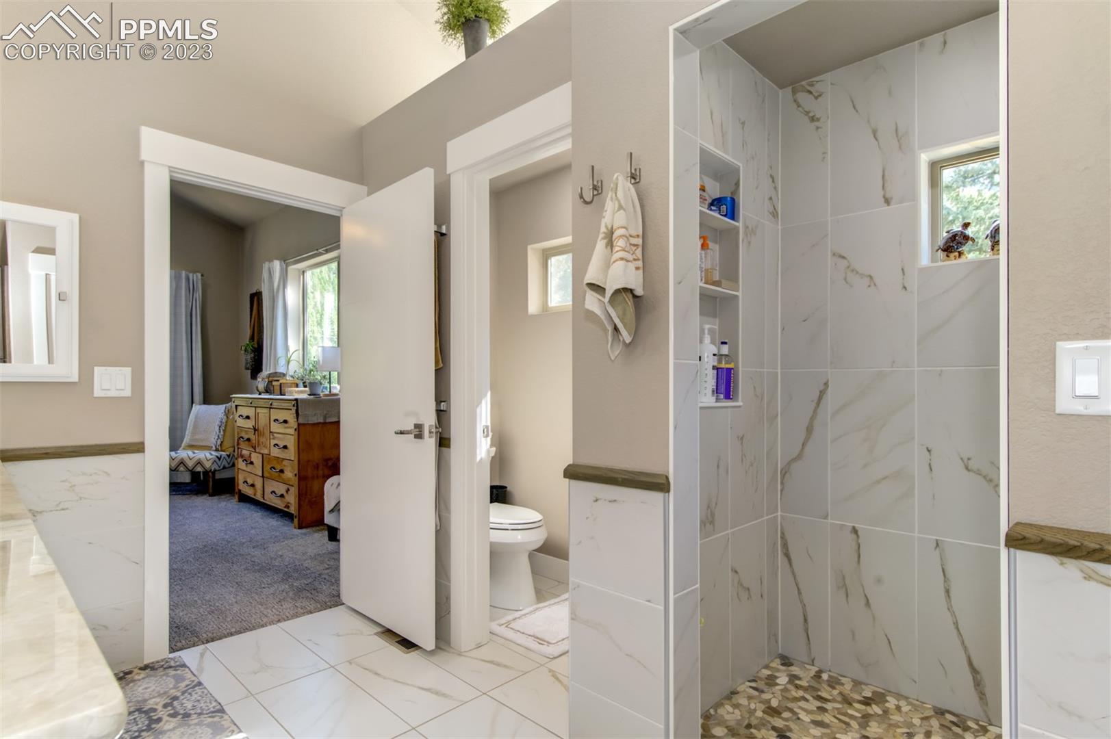 5020 South High Ridge View Manitou Springs, CO 80829 - Photo 26 of 46 View of the bathroom looking into the shower and primary bedroom!