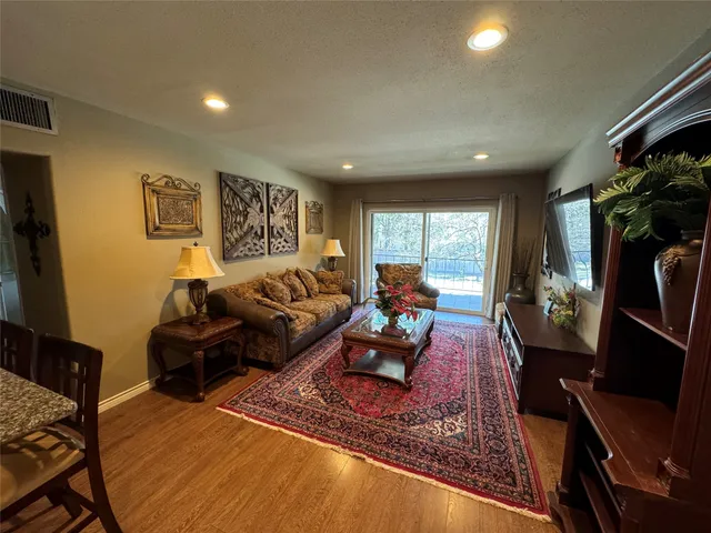 a living room with furniture rug and window