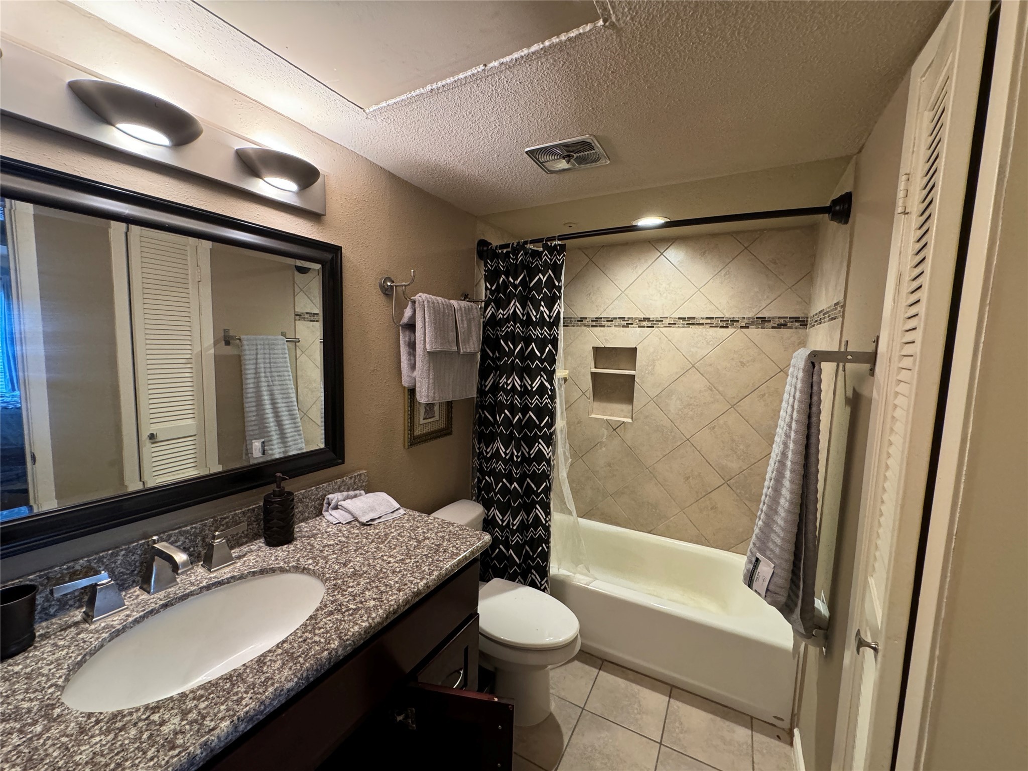 2220 South Piney Point Road, Unit 208 Houston, TX 77063 - Photo 6 of 10 a bathroom with a granite countertop sink toilet and shower