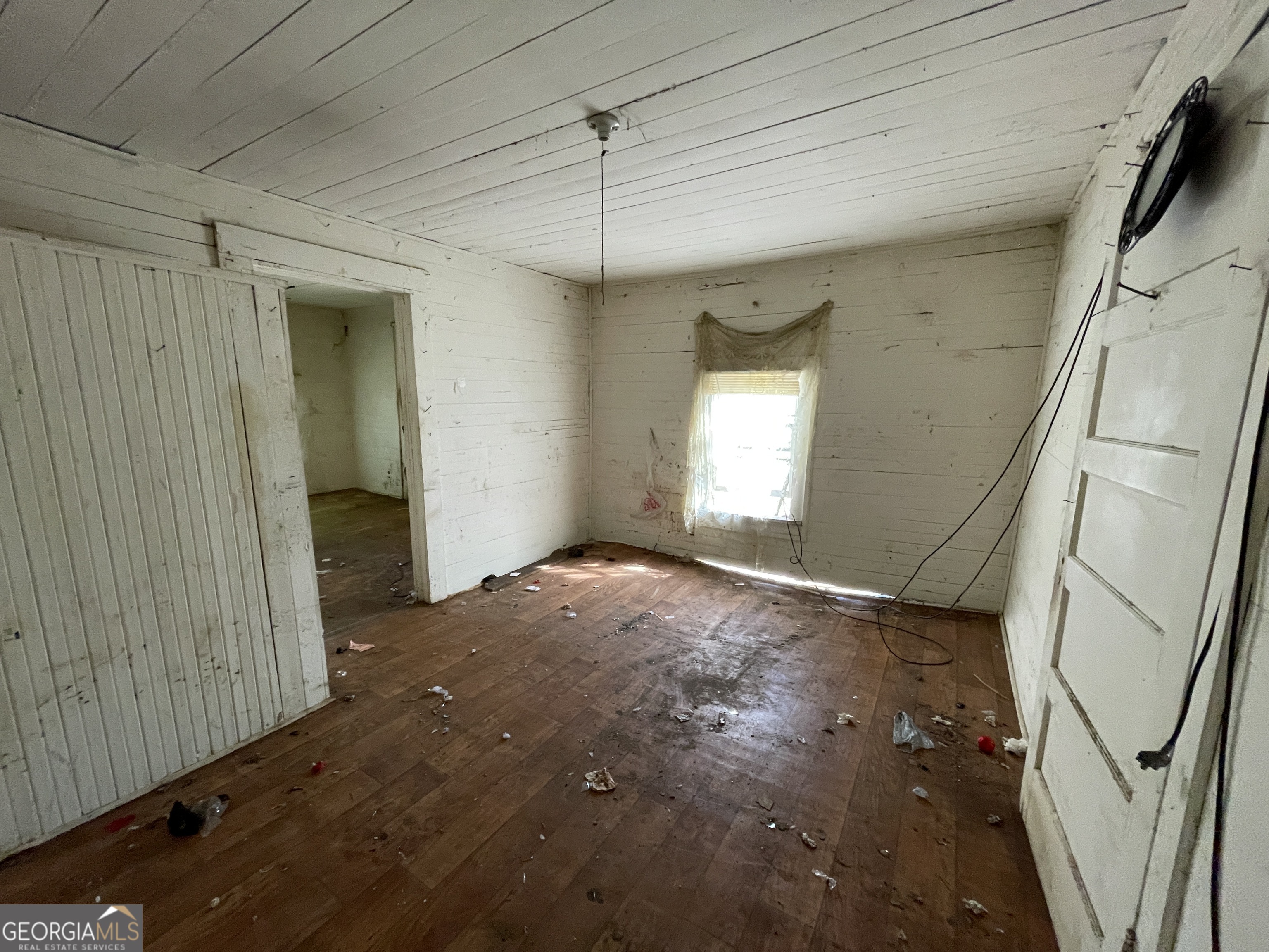 129 7th Street Cochran, GA 31014 - Photo 8 of 18 a view of empty room with window and wooden floor