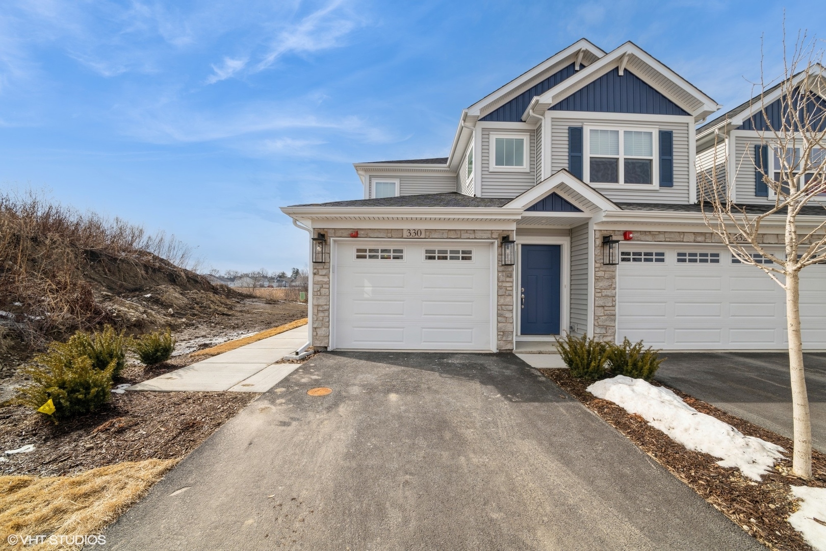385 Masters Drive Addison, IL 60101 - Photo 2 of 17 a front view of a house with a yard and garage