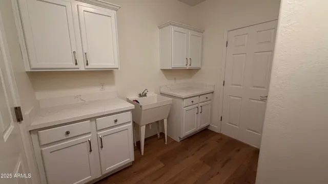 a kitchen with white cabinets and white appliances