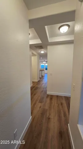 a view of a hallway with wooden floor