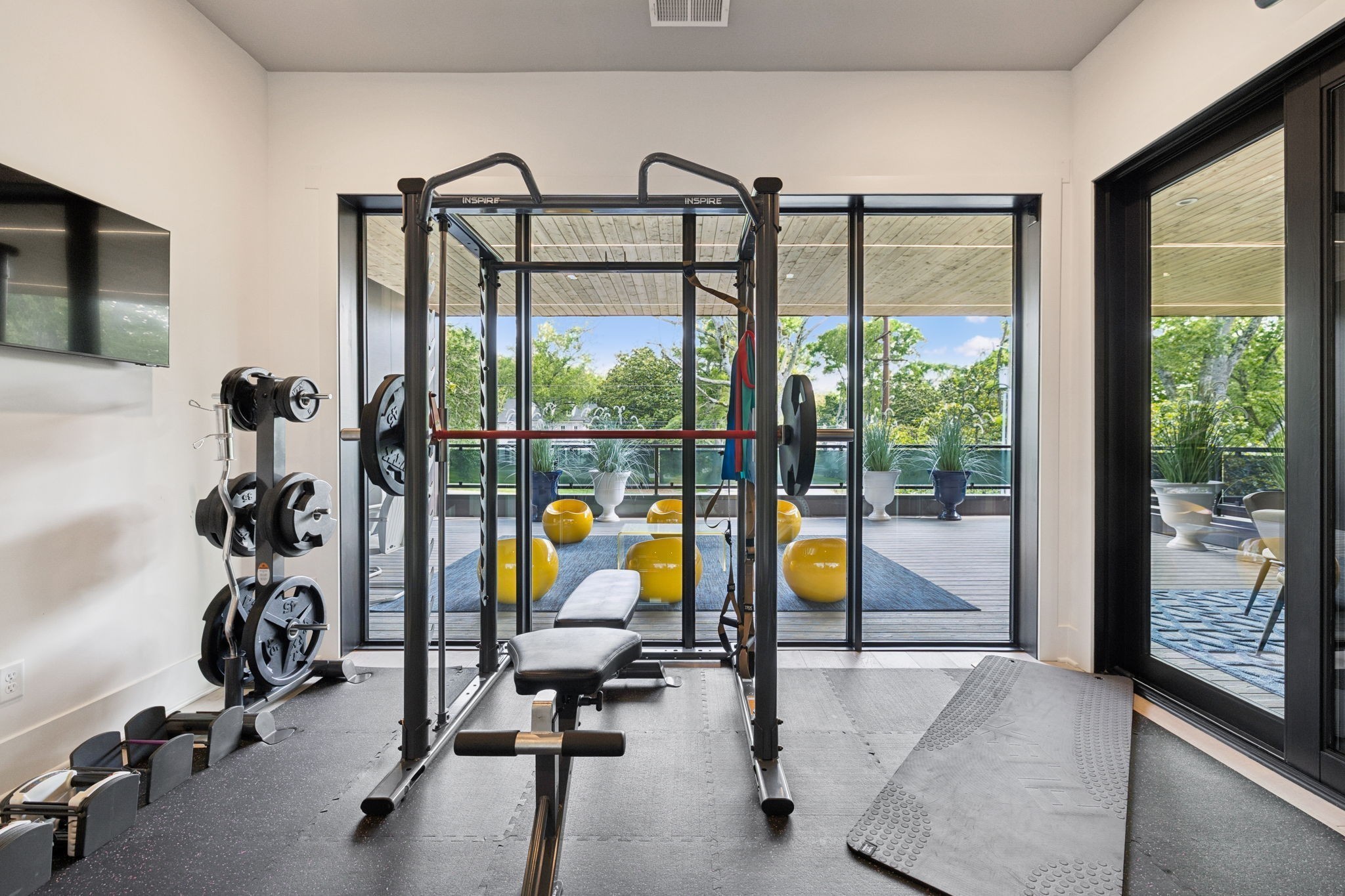 3916 Harding Place Nashville, TN 37215 - Photo 42 of 85 a view of a room with gym equipment and floor to ceiling window