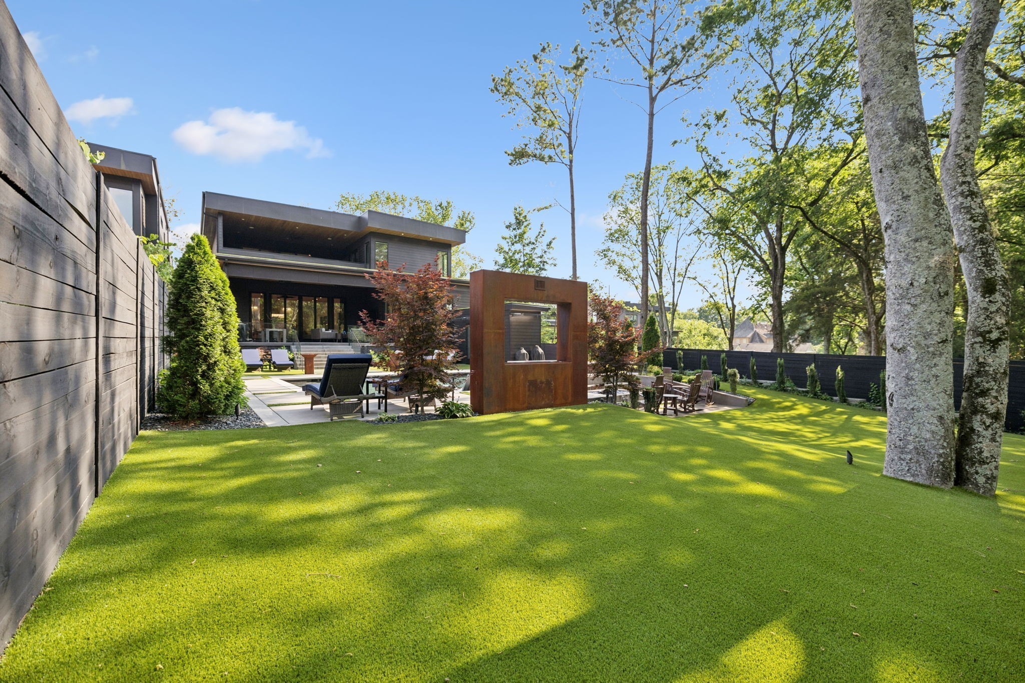 3916 Harding Place Nashville, TN 37215 - Photo 67 of 85 a view of a patio with table and chairs potted plants and large tree