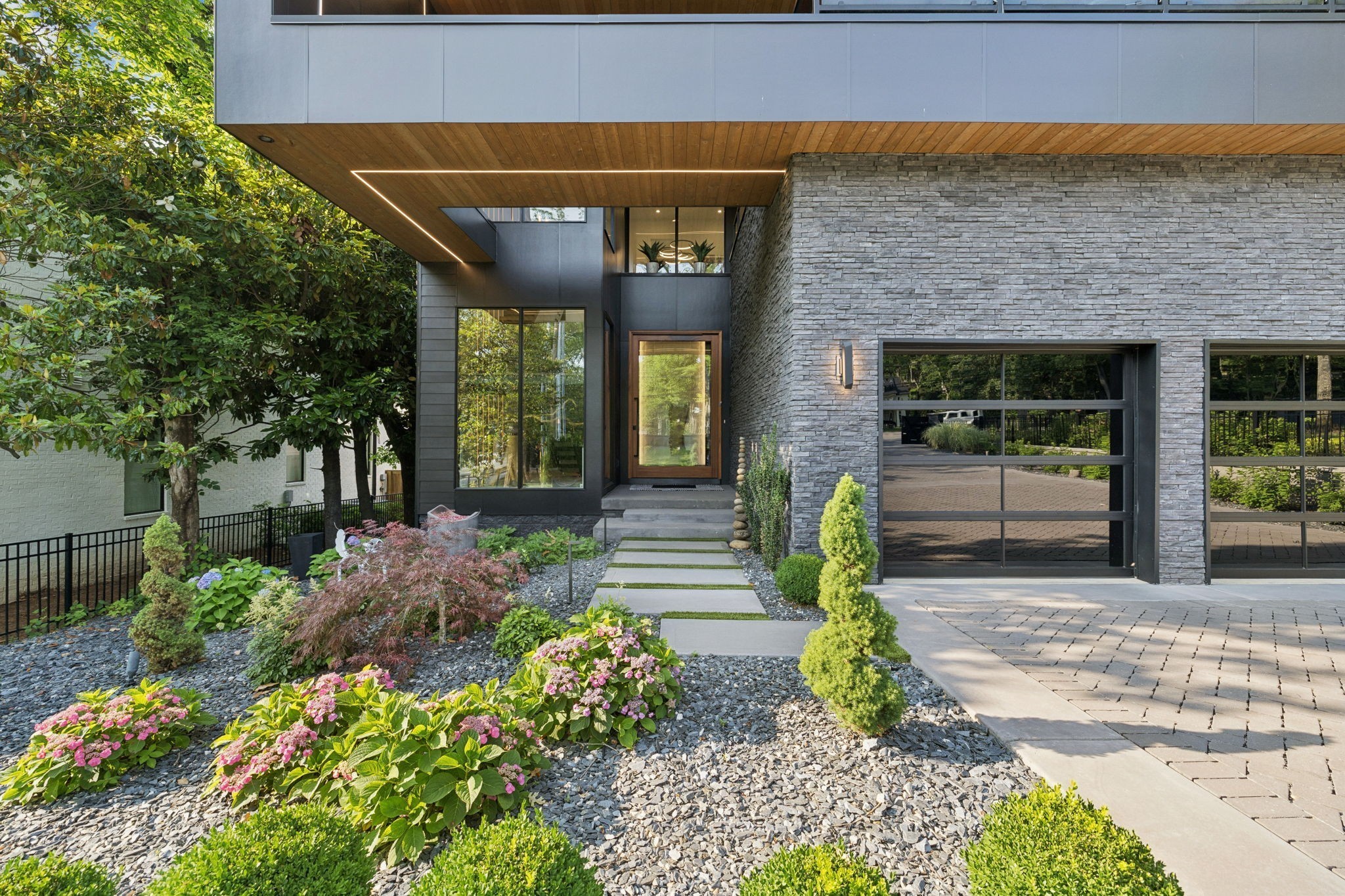 3916 Harding Place Nashville, TN 37215 - Photo 7 of 85 a view of a house with large windows and plants