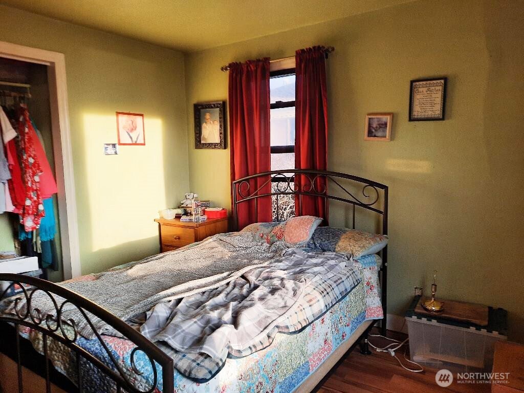913 East 7th Street Port Angeles, WA 98362 - Photo 13 of 17 a bedroom with a bed and dresser with mirror