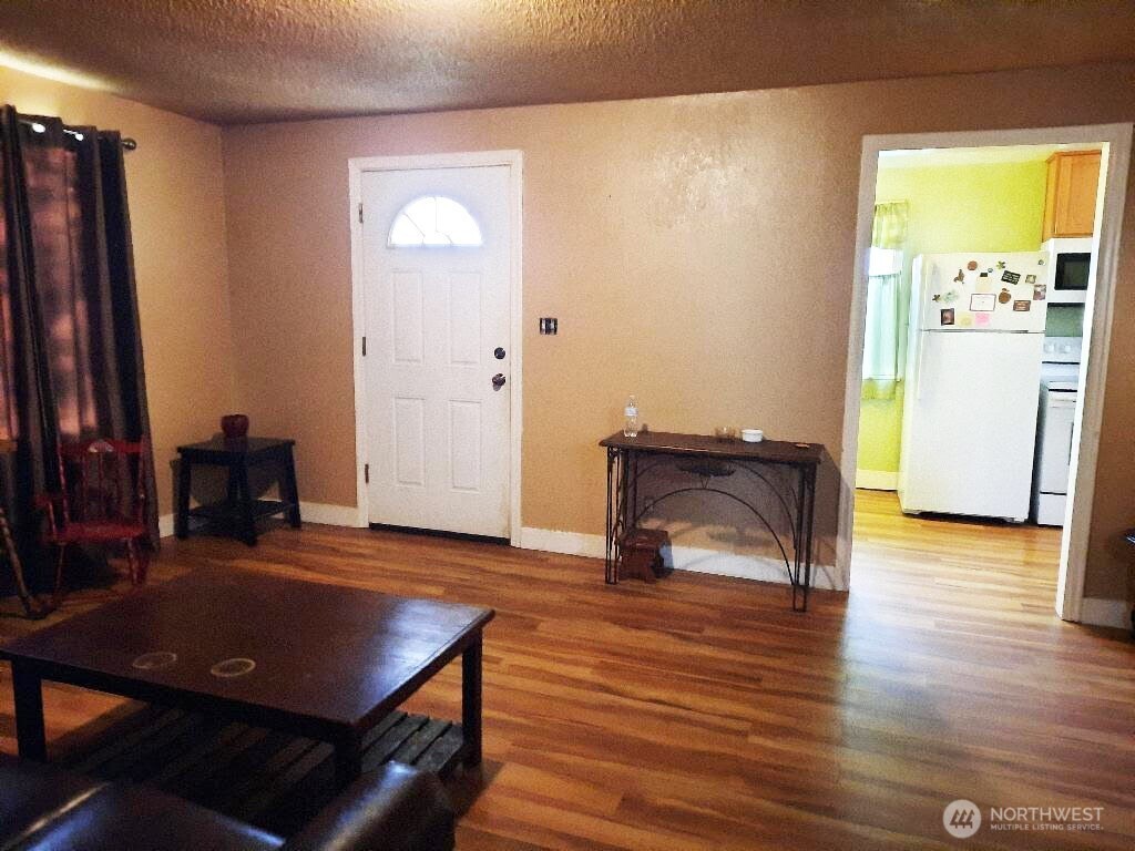 913 East 7th Street Port Angeles, WA 98362 - Photo 2 of 17 a living room with furniture and a table