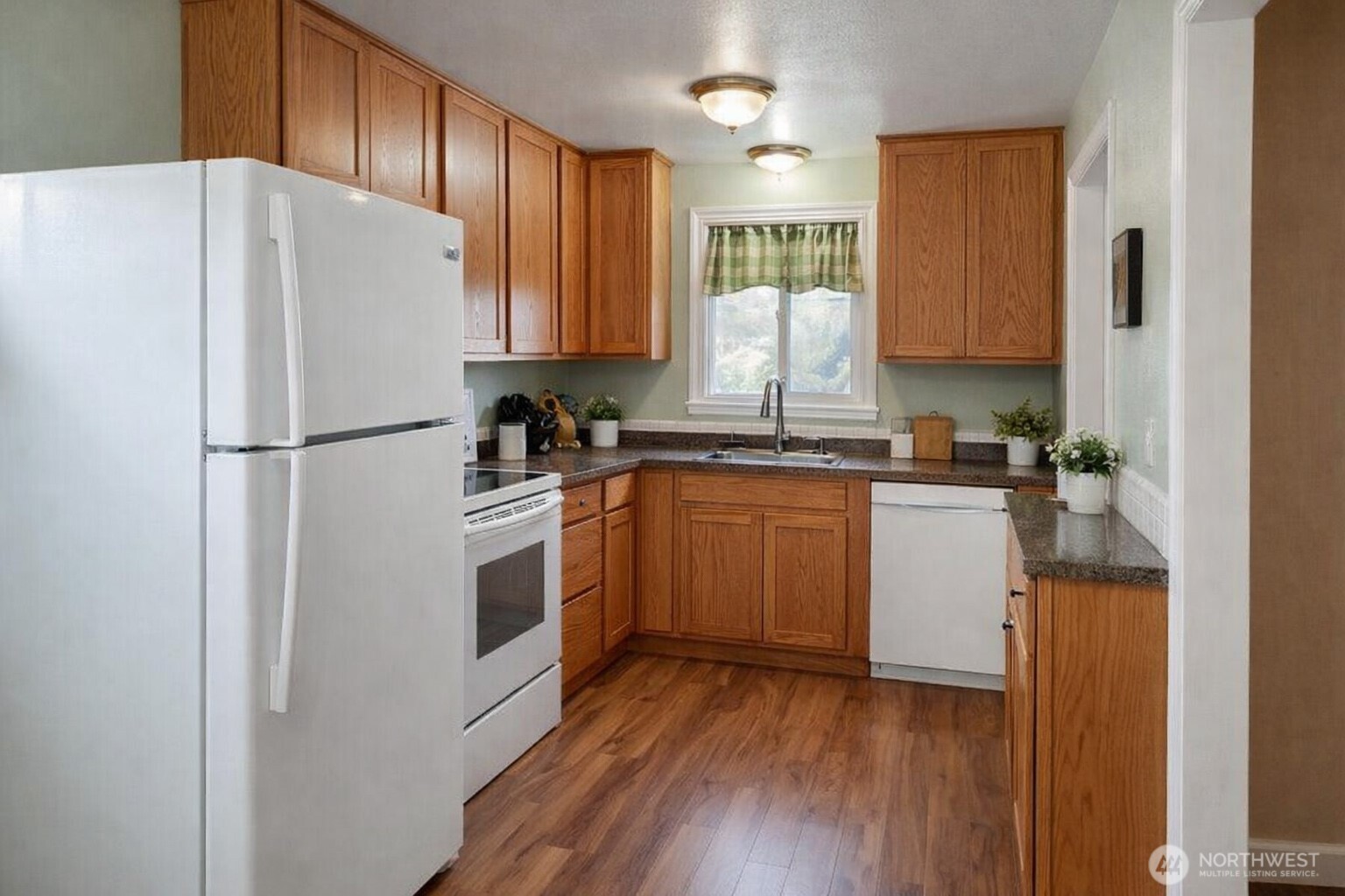 913 East 7th Street Port Angeles, WA 98362 - Photo 3 of 17 a white refrigerator freezer sitting inside of a kitchen