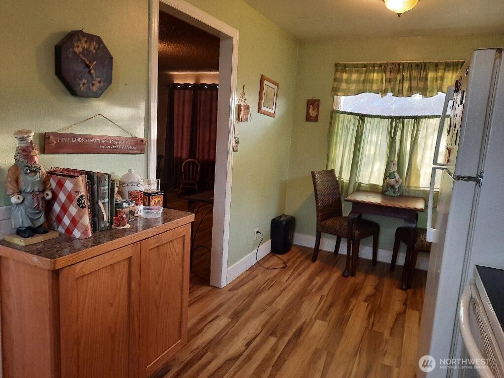 913 East 7th Street Port Angeles, WA 98362 - Photo 5 of 17 a view of a dining room with furniture window and wooden floor