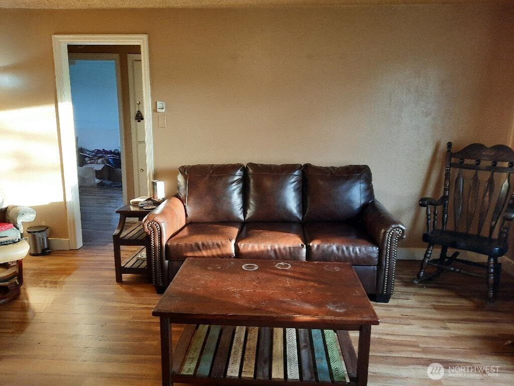 913 East 7th Street Port Angeles, WA 98362 - Photo 7 of 17 a blue chair sitting in front of a room