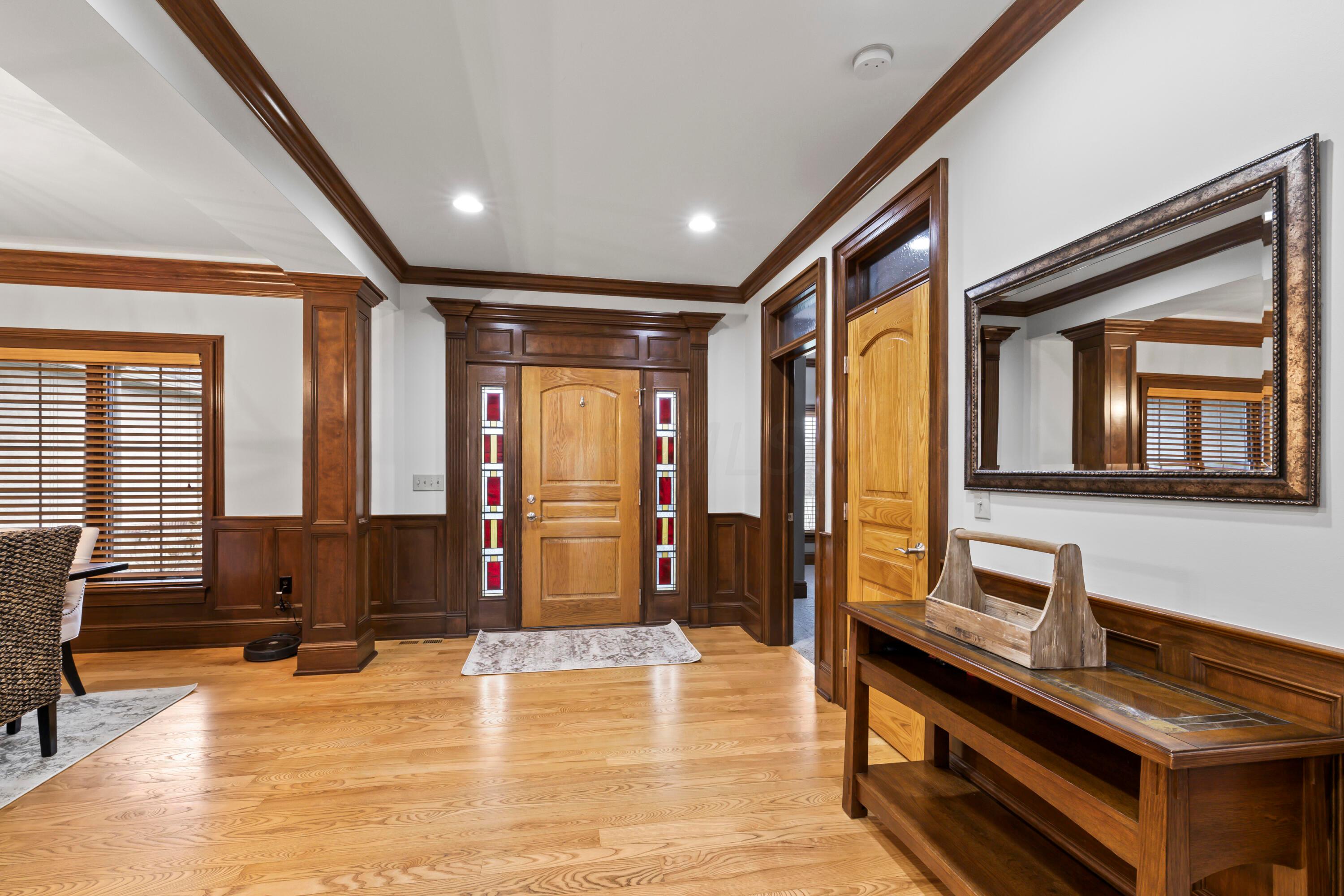 6043 Dublin Road Delaware, OH 43015 - Photo 3 of 98 • Hardwood flooring
• Ivory painted & wainscoted
walls
• Sidelights by front door
• Crown molding
• Can lighting
• Coat closet