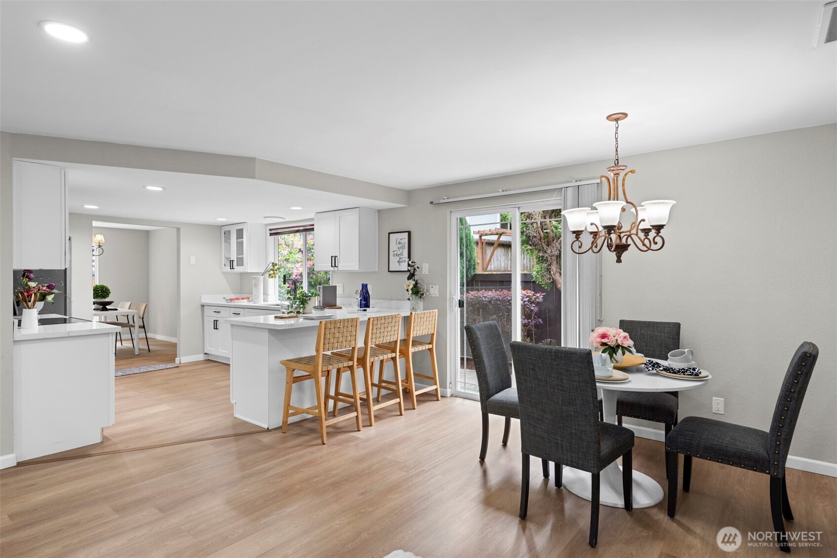 12311 Southeast 96th Place Renton, WA 98056 - Photo 5 of 20 a dining room with furniture a chandelier and wooden floor