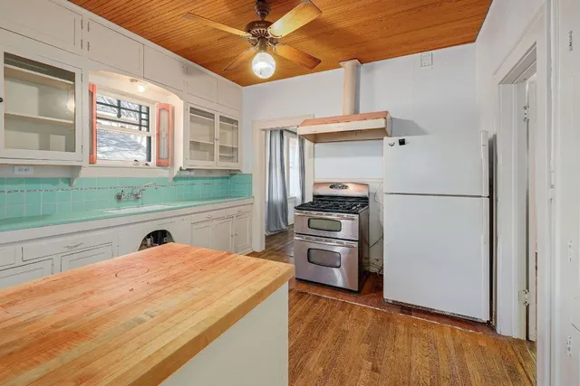 a kitchen with refrigerator and cabinets