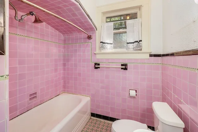 a bathroom with a sink a toilet a mirror and bathtub