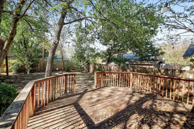 a view of balcony with wooden floor and fence