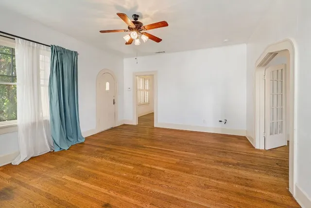 a view of a bedroom with a large bed and a chandelier