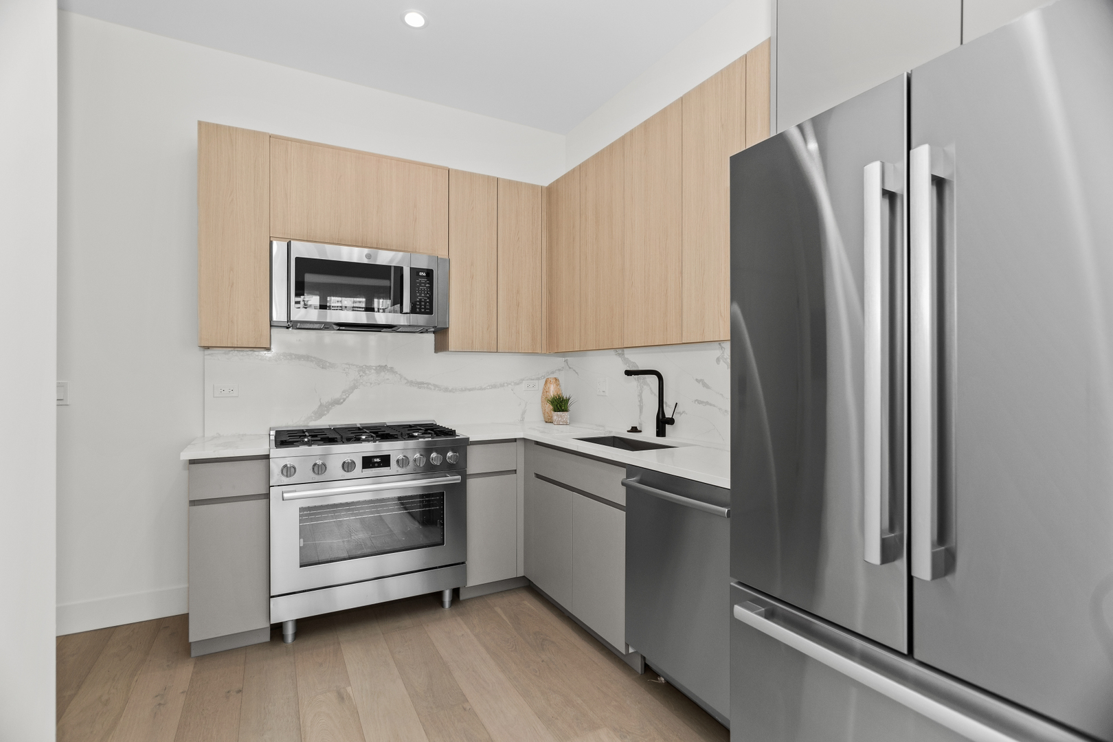 153 West Ohio Street, Unit 504 Chicago, IL 60654 - Photo 4 of 13 a kitchen with stainless steel appliances a stove a refrigerator and a microwave