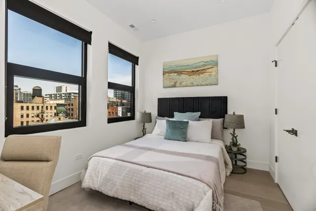 a bedroom with a large bed and a couch