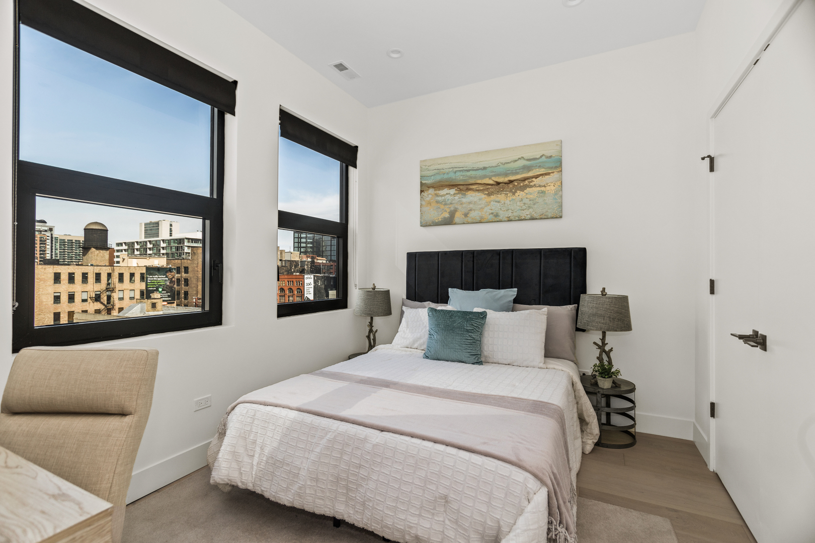 153 West Ohio Street, Unit 504 Chicago, IL 60654 - Photo 5 of 13 a bedroom with a large bed and a couch