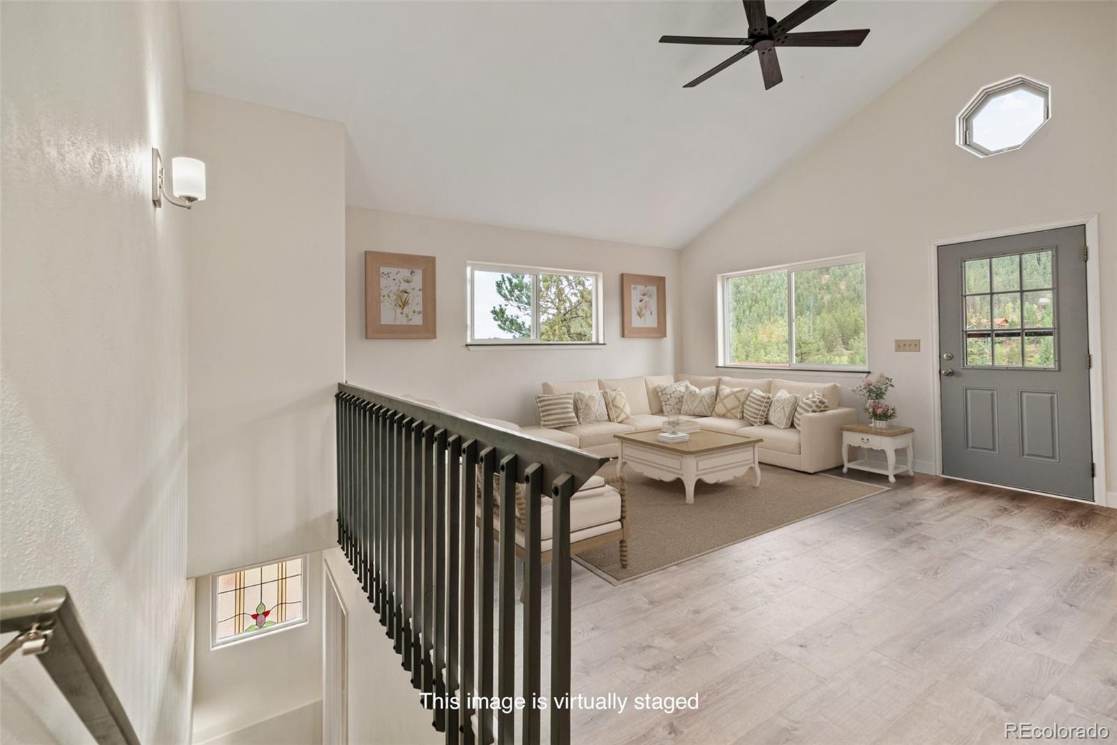 241 Schooley Road Bailey, CO 80421 - Photo 13 of 35 a living room with couches and a window with wooden floor