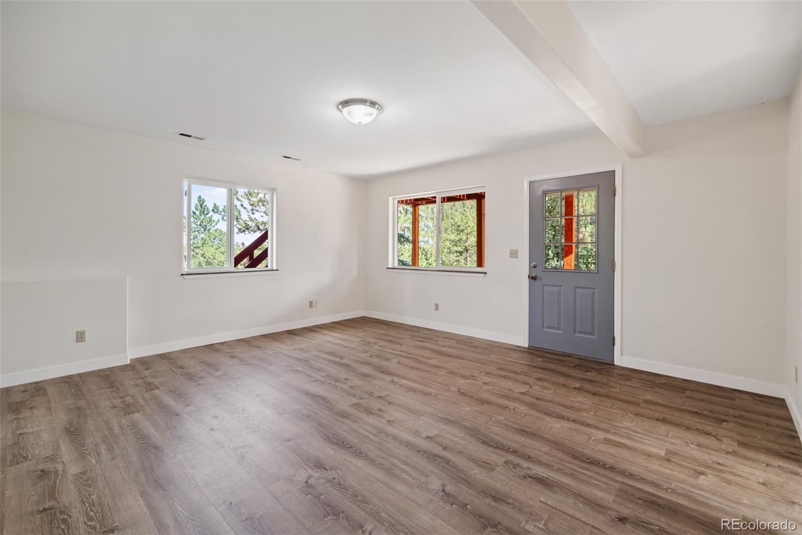 241 Schooley Road Bailey, CO 80421 - Photo 19 of 35 an empty room with windows and exposed bricks
