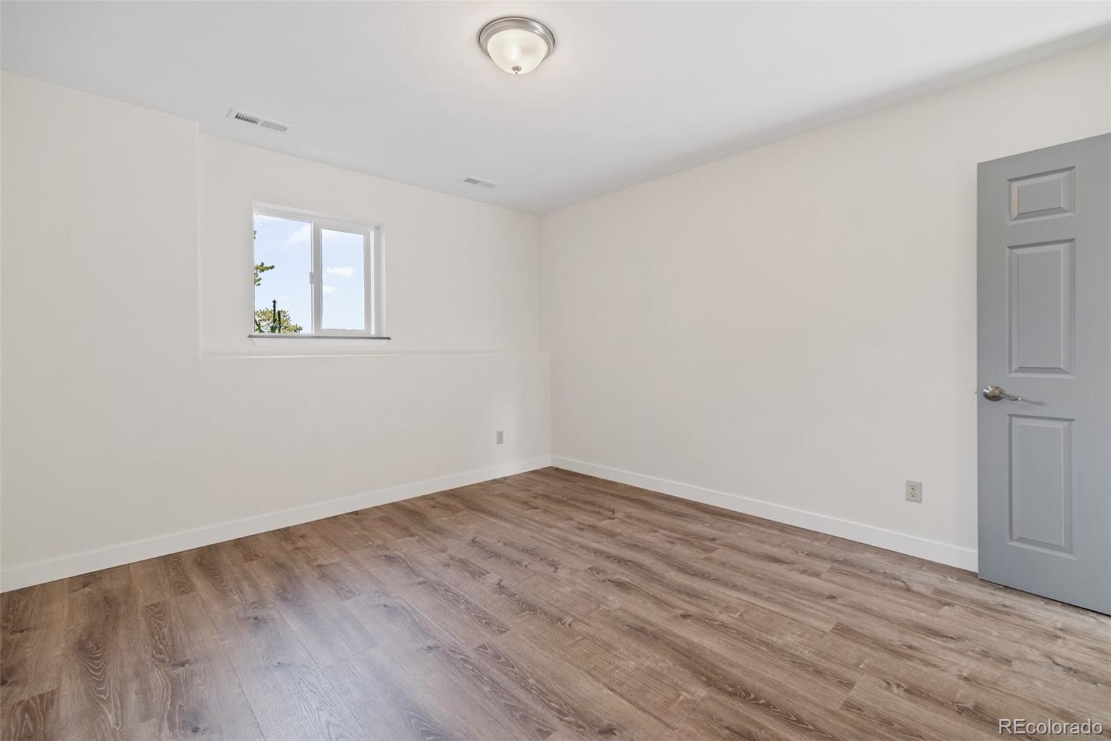 241 Schooley Road Bailey, CO 80421 - Photo 20 of 35 an empty room with wooden floor and windows