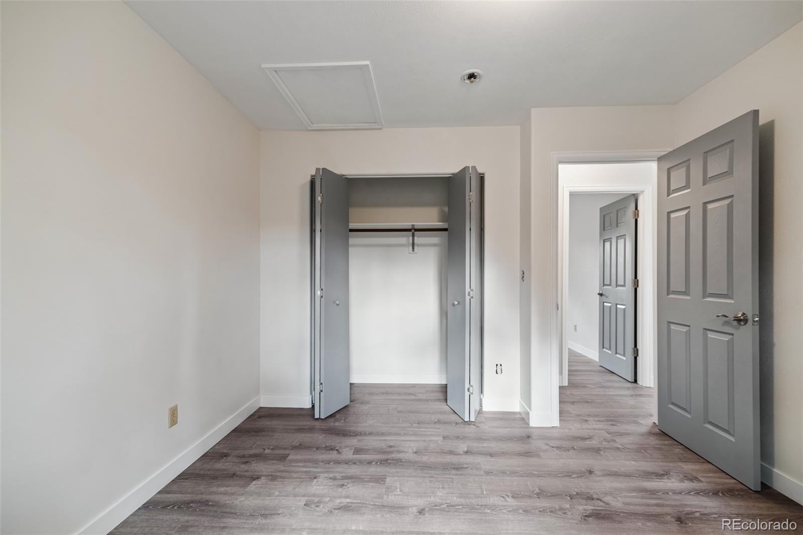 241 Schooley Road Bailey, CO 80421 - Photo 24 of 35 a view of an empty room with closet and wooden floor