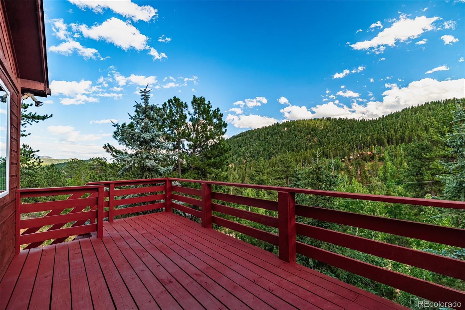 241 Schooley Road Bailey, CO 80421 - Photo 4 of 35 a view of outdoor space with wooden floor and outdoor seating