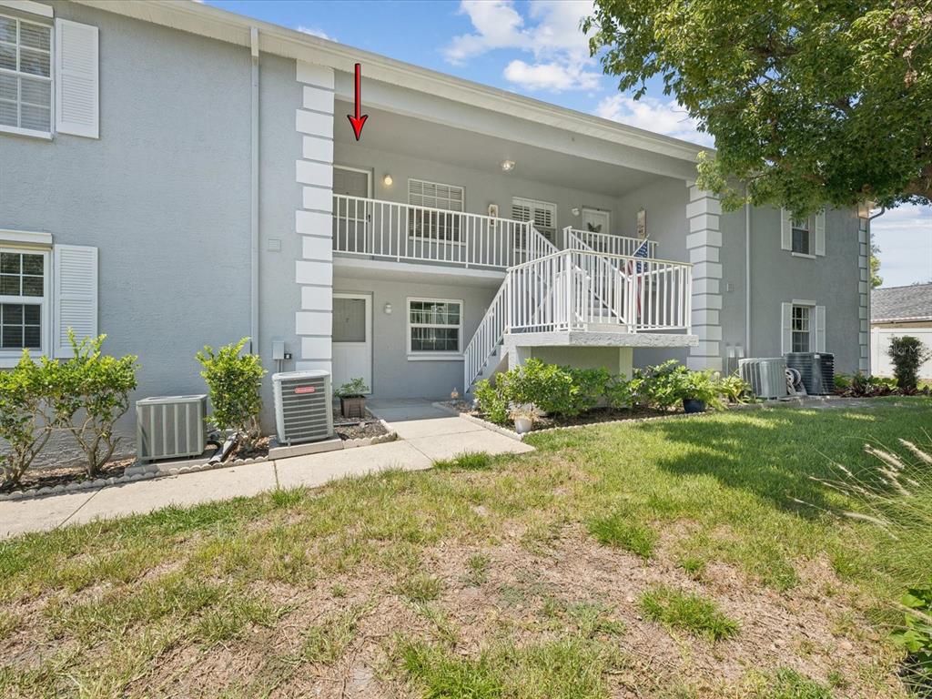 12141 Spartan Way, Unit 202 Hudson, FL 34667 - Photo 1 of 45 a view of a house with backyard and sitting area