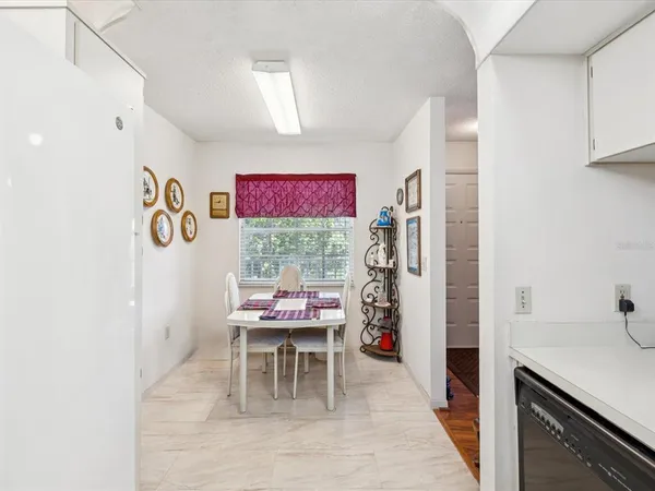 a view of a kitchen with kitchen island a sink and a stove with wooden floor